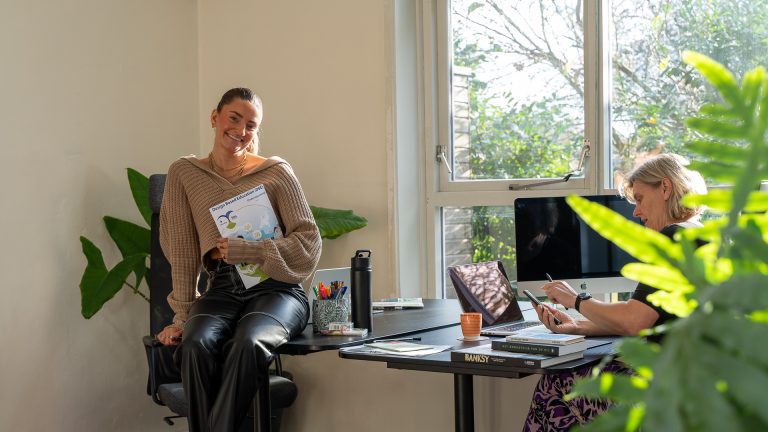 Vrouw aan het werk bij een bureau.